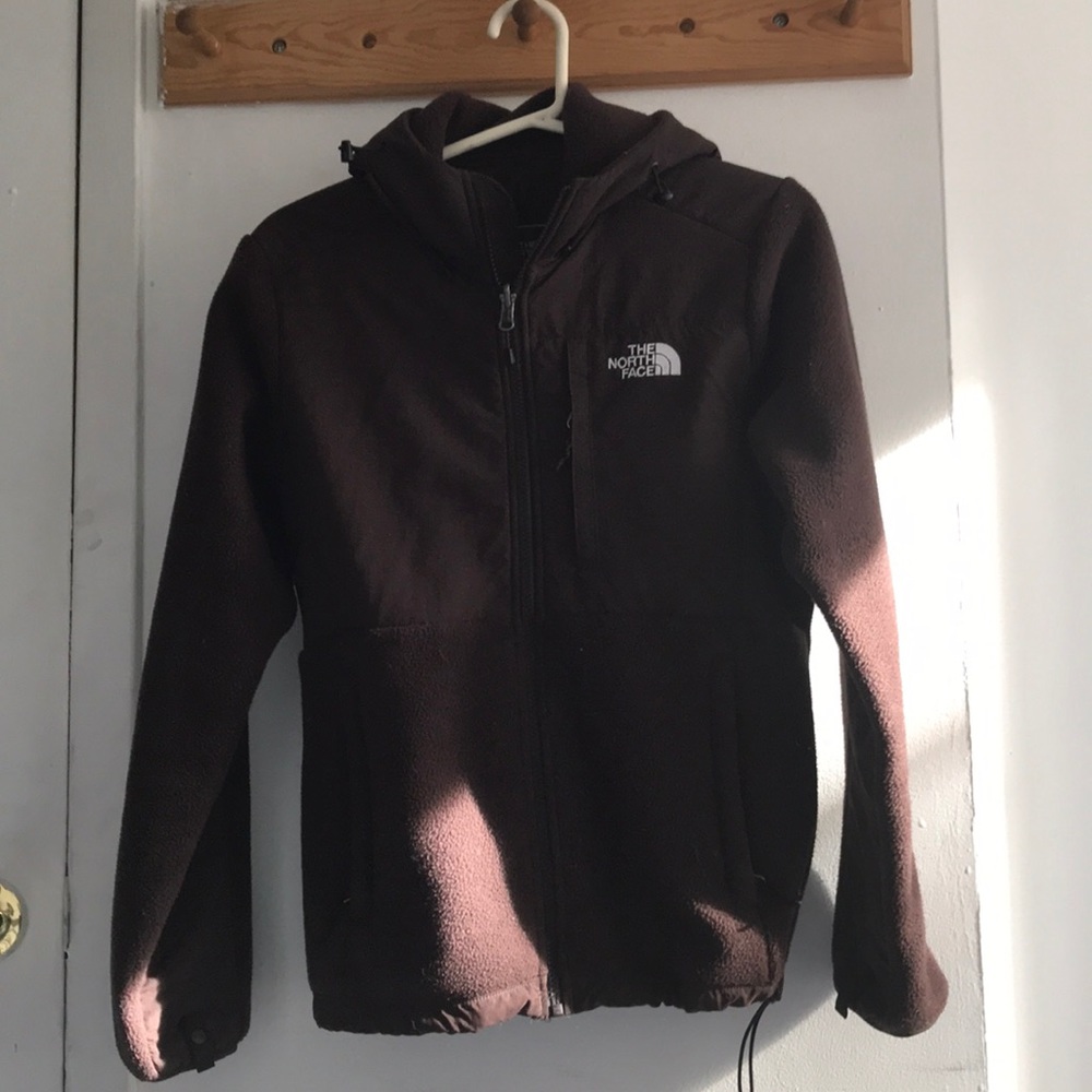 brown woman’s north face jacket